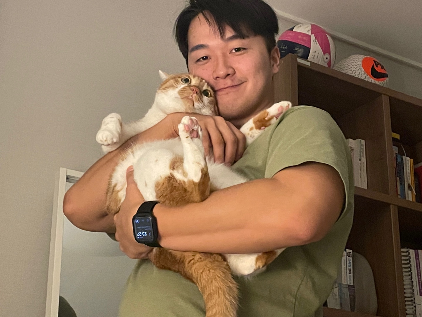 Dohyeon Dodo Park holding an orange-and-white cat